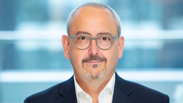 a man wearing glasses and a suit