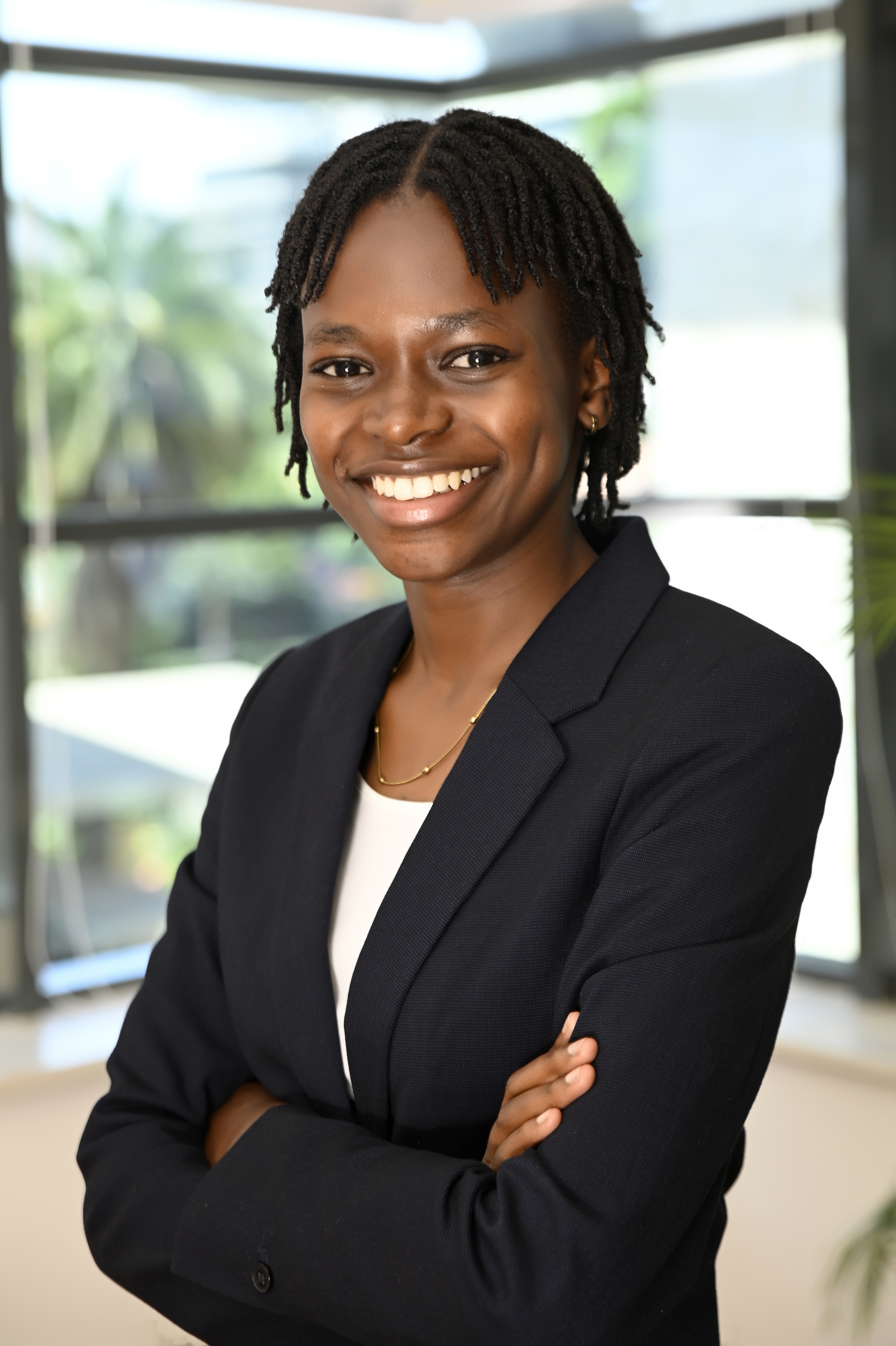 a woman smiling with her arms crossed