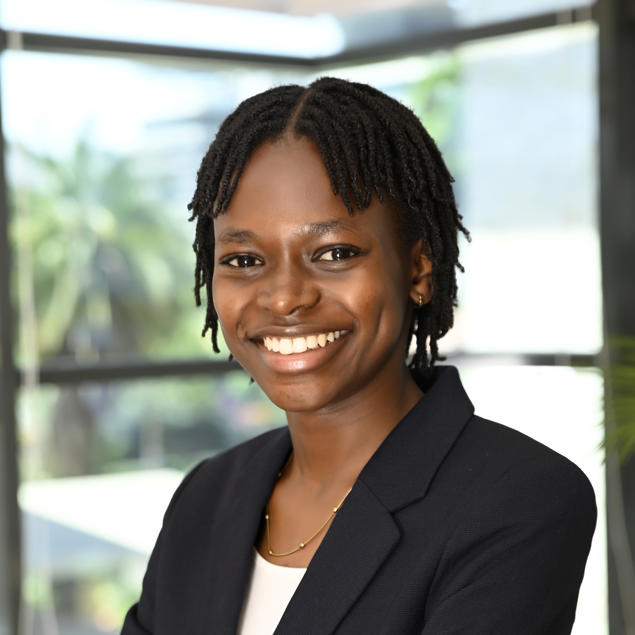 a woman smiling with her arms crossed