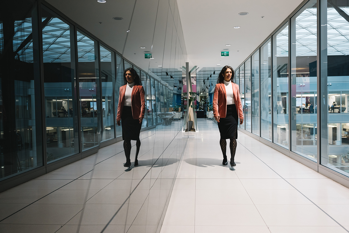 two women walking in a hallway