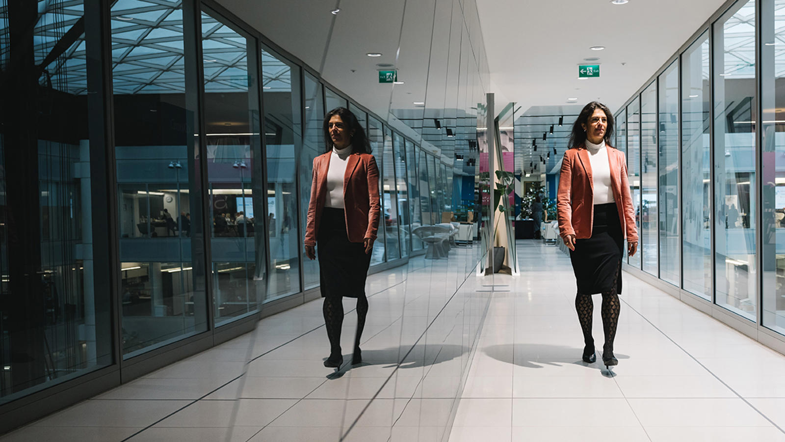 two women walking in a hallway