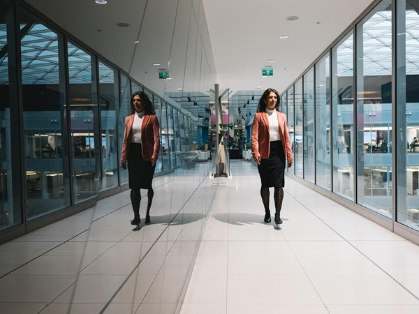 two women walking in a hallway